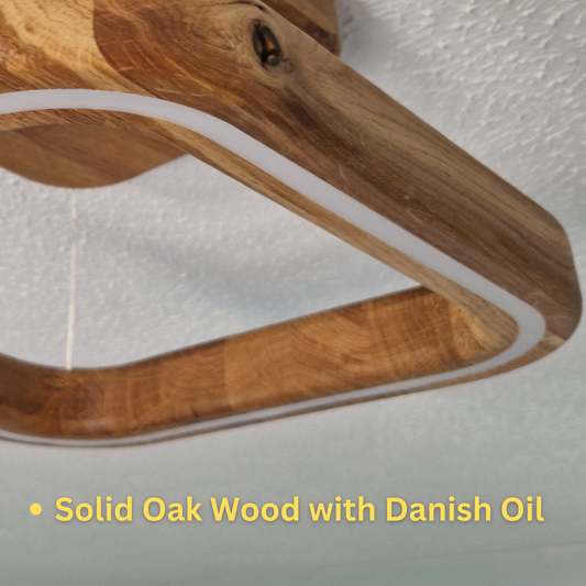 Close-up of a curved wooden object with a natural oak wood finish and Danish oil, showing the grain and a white accent line, with text overlay reading 'Solid Oak Wood with Danish Oil'.