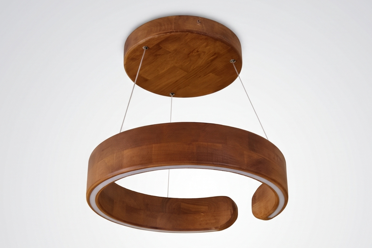 A modern wooden pendant light with a large circular ring shade and a smaller round ceiling canopy, suspended by thin cables against a plain white background.