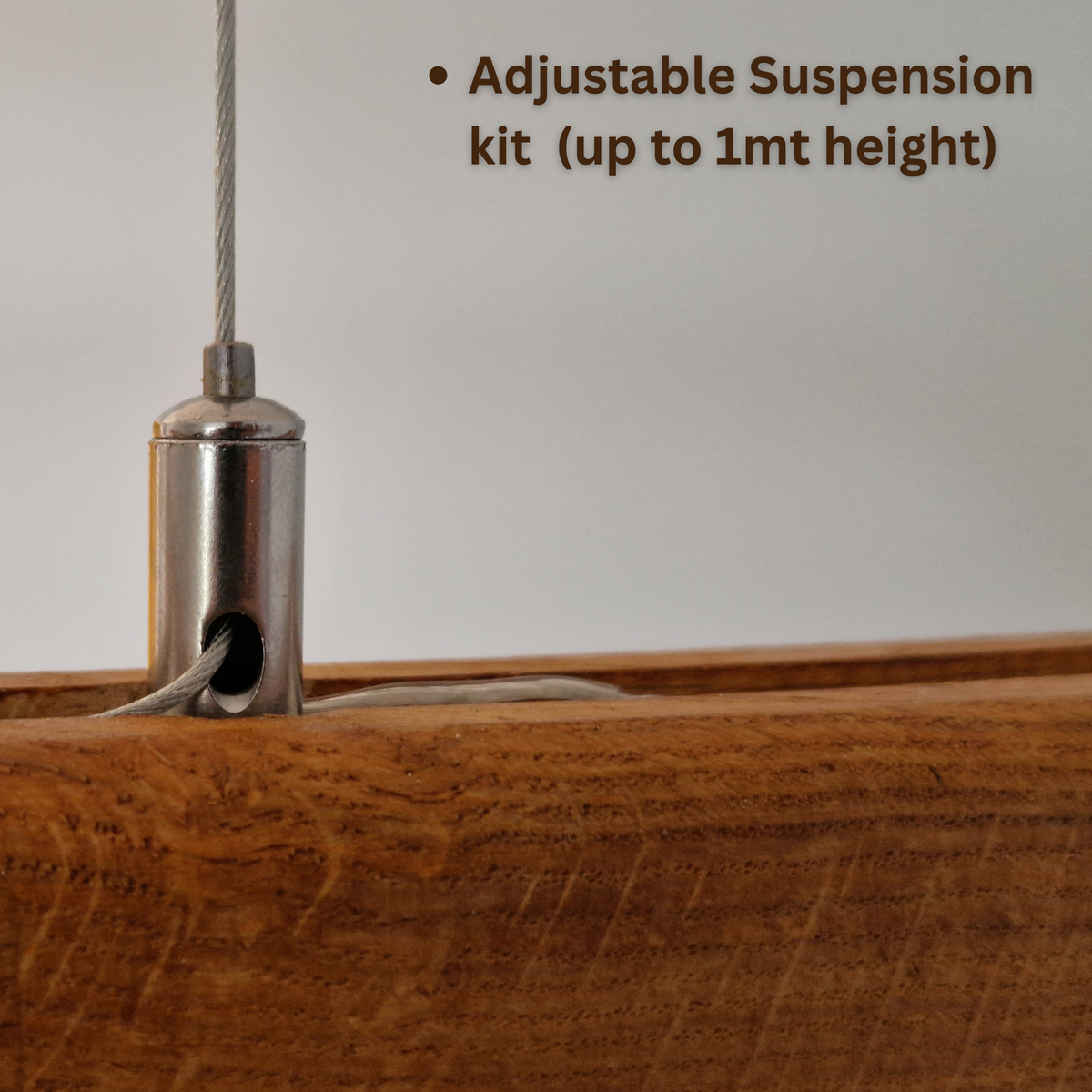 Close-up of a stainless steel adjustable suspension kit component attached to a wooden surface, with text reading 'Adjustable Suspension kit (up to 1mt height)'.